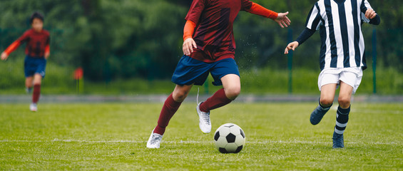 Soccer football players chasing ball on field