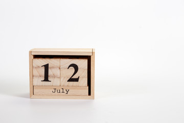 Wooden calendar July 12 on a white background