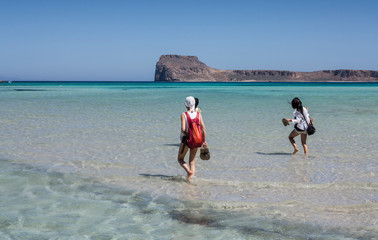 women walking on clear water