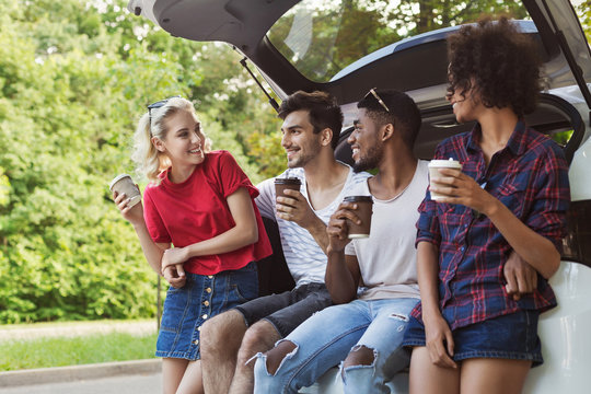 Happy travelers sitting in car back