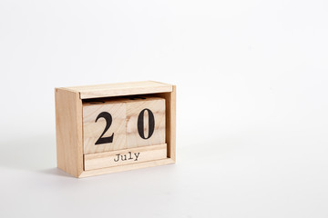 Wooden calendar July 20 on a white background