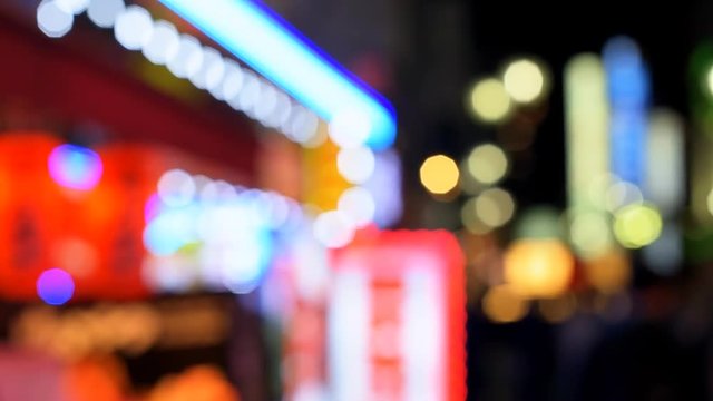 Tokyo, Japan Shinjuku district at night with nightlife background of bokeh lights on street flickering shining slow motion