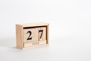 Wooden calendar July 27 on a white background