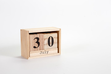 Wooden calendar July 30 on a white background
