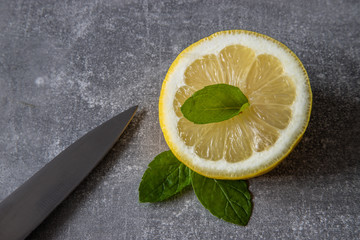 Cytryna z liśćmi mięty oraz nożem © andsko