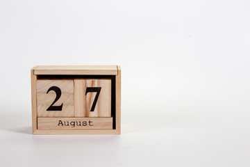 Wooden calendar August 27 on a white background