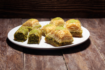 Middle eastern or arabic dishes. Turkish Dessert Baklava with pistachio on dishes