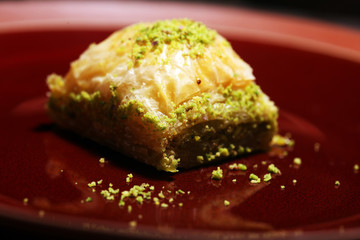 Middle eastern or arabic dishes. Turkish Dessert Baklava with pistachio on dishes