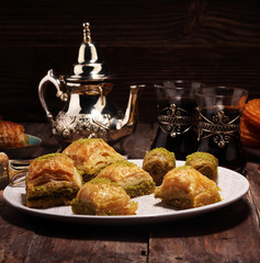 Middle eastern or arabic dishes. Turkish Dessert Baklava with pistachio on dishes