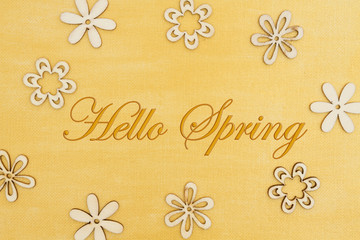 Hello Spring message with wood flower petals on hand painted distressed gold