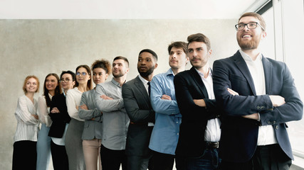 Business team standing in row with boss headed