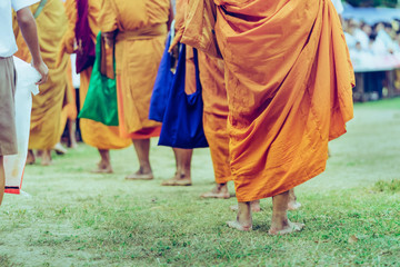 Fototapeta premium Teachers and students together make merit to give food offerings to a Buddhist monk on important religious days at school.