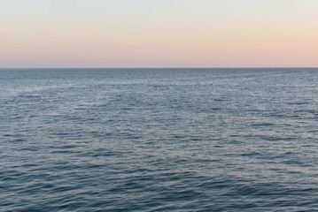 Obraz premium Evening landscape of the Black Sea, calm water and the evening sky in the city of Gelendzhik, Russia
