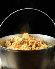 Pilaf is an oriental dish of boiled rice with fat and slices of meat and spices