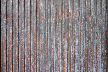 Rusty sheet of corrugated metal wall textured background