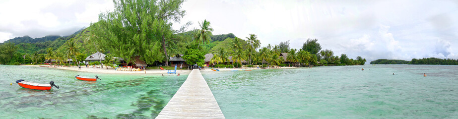 Fototapeta na wymiar Wooden Walkway, Dock on tropical beach, clear water, Moorea, Tahiti French Polynesia. Panoramic Photo