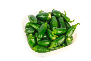 Plastic Bowl filled with Jalapeno Peppers on White BG with Copy Space