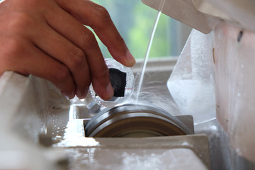 Professional ophthalmology instrument in clinic office and optics., Optical Shop, Grind the lens into the eyeglass