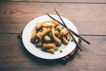 Baby Corn Manchurian dry - popular Indo-chinese starter recipe. selective focus