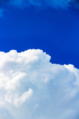 Abstract skyscape with a cumulus cloud and deep blue sky