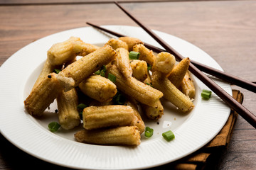 Baby Corn Manchurian dry - popular Indo-chinese starter recipe. selective focus