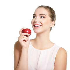 Beauty female portrait. Young attractive woman posing at studio with apple over white background. Beautiful girl with perfect smile. Model with perfect make-up