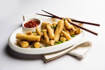 Baby Corn Manchurian dry - popular Indo-chinese starter recipe. selective focus