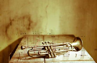 old trumpet on sheet music © corradobarattaphotos
