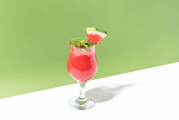 Fresh water melon juice and watermelon slice on color background. summer drink.