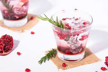 Pomegranate juice with ripe pomegranate on white background. summer drink.