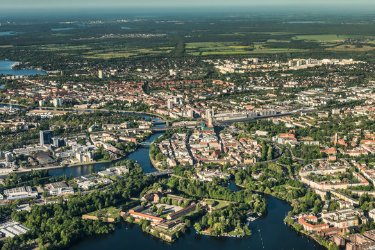 old town Berlin Spandau with town hall, train station and "Spandau Arcaden" in front, with the river Havel and Wannsee in the background