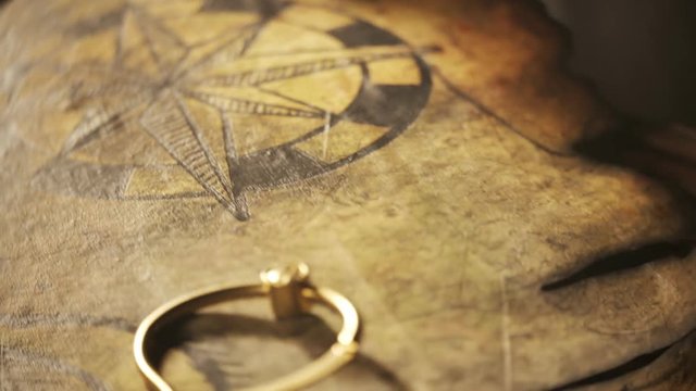 Old, worn, detailed, handmade treasure map on a cartoon tavern table close-up.4K