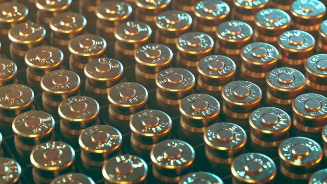 Rows of .50 BMG machine gun ammunition in plastic container. Loop animation.