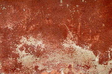 Red grunge wall tone texture background. Peeled plaster.