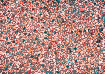 Closeup of coral coloured and turquoise abstract mosaic ceramic tiles patterned background