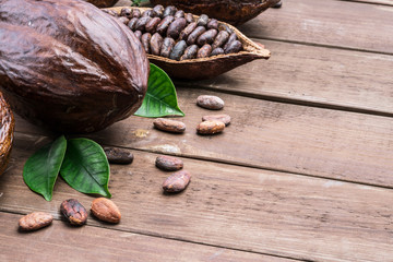 Cocoa pod and cocoa beans on the wooden table. Top view.