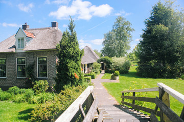 View of famous typical Dutch village Giethoorn with canals in the province of 'Overijssel. The beautiful Traditional Dutch House and gardening city is know as 