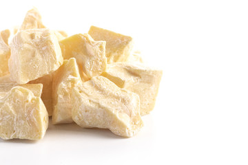 Chunks of Raw Organic Cocoa Butter on a White Background
