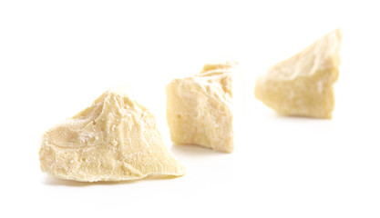 Chunks of Raw Organic Cocoa Butter on a White Background