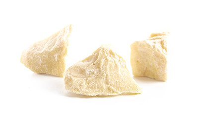 Chunks of Raw Organic Cocoa Butter on a White Background
