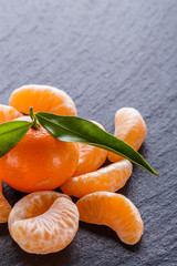 juicy mandarin on a dark stone background