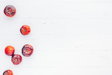 Tomatoes Mar Azul on white wooden table background