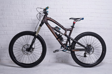 Fototapeta na wymiar Full suspension mountain bike on a brick wall background.