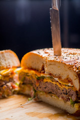  large burger in the cut. Thick layers of cutlet, cheese and vegetables with sauces