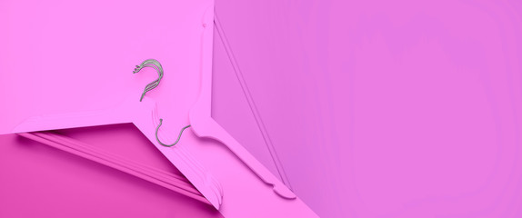 Creative fashion concept. Flat lay top view colored wooden hangers on pink background minimalism style pop-art. Sale discount store shopping concept, design empty hanger. Beauty feminine blog