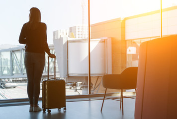 Young woman with luggage in the airport.