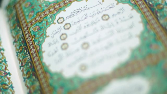the holy Quran muslim holy book, detail of surah in slow motion 