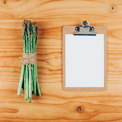 Fresh green asparagus with paper clipboard mockup