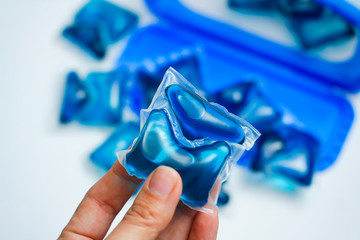 Hand hold washing gel capsule. Liquid detergent for washing machine. Blue duo soft soap. Fabric...