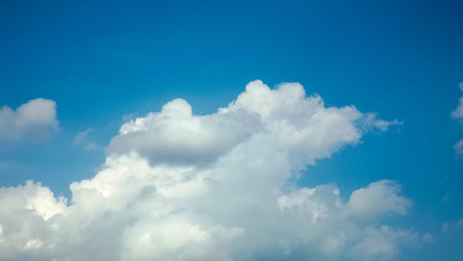 white clouds in the bright blue sky